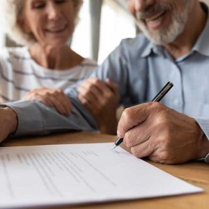 Elderly couple writing will with Will Writing Service Enfield Kingsbridge Wills