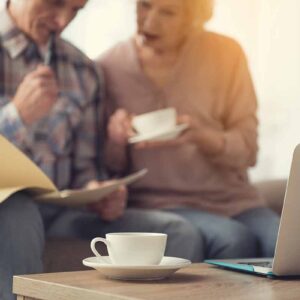 An elderly couple writing up a will together and discussing poor will drafting