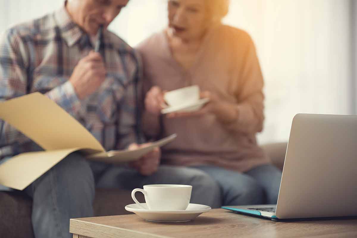 An elderly couple writing up a will together and discussing poor will drafting