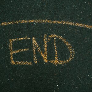 An image with the word end drawn on the ground in orange chalk. This post is headed The End Of The World Is Nigh