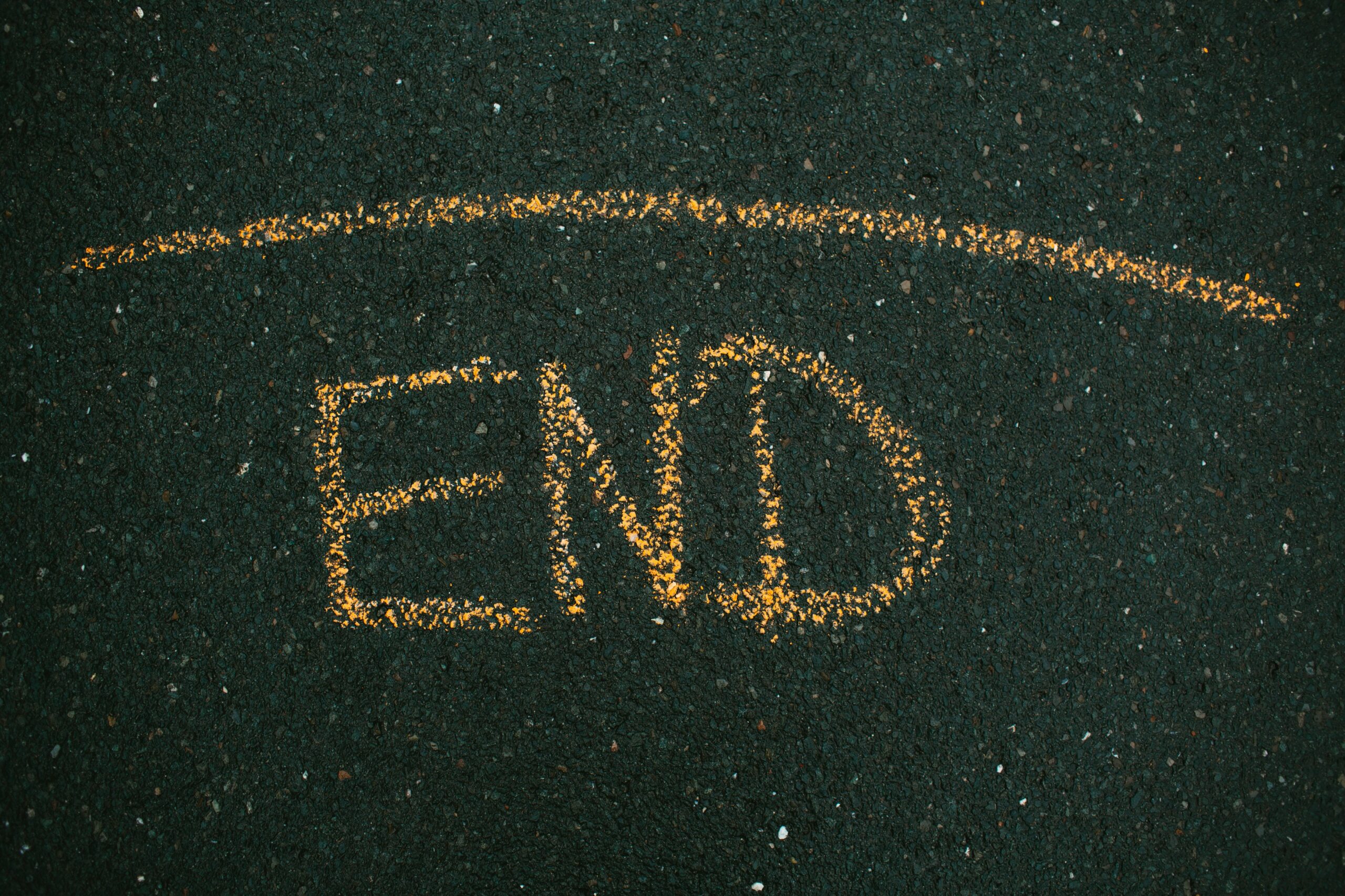 An image with the word end drawn on the ground in orange chalk. This post is headed The End Of The World Is Nigh